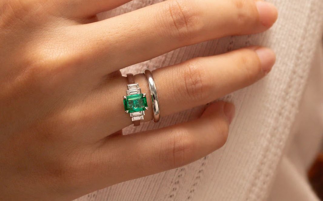 Straight wedding band worn with an emerald engagement ring — Bonnot Paris